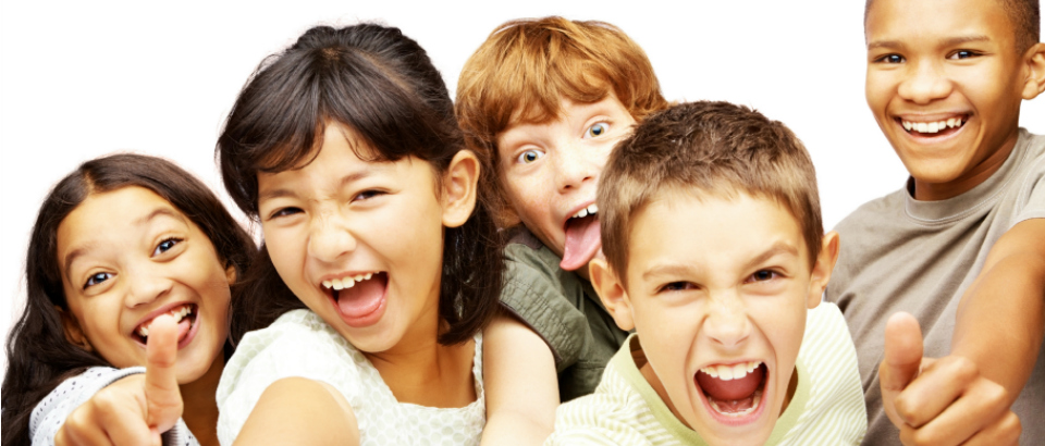 Happy young children making signs in joy against white background